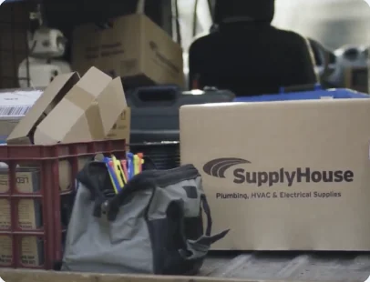 SupplyHouse box and tool bag in a work van