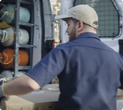 Technician loading a delivery into a service van