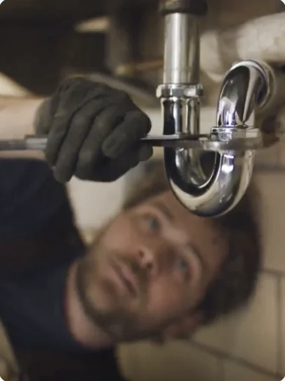 Plumber tightening a sink trap