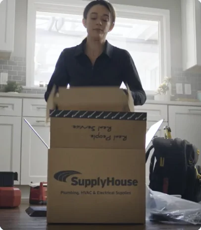 Homeowner unpacking a SupplyHouse box